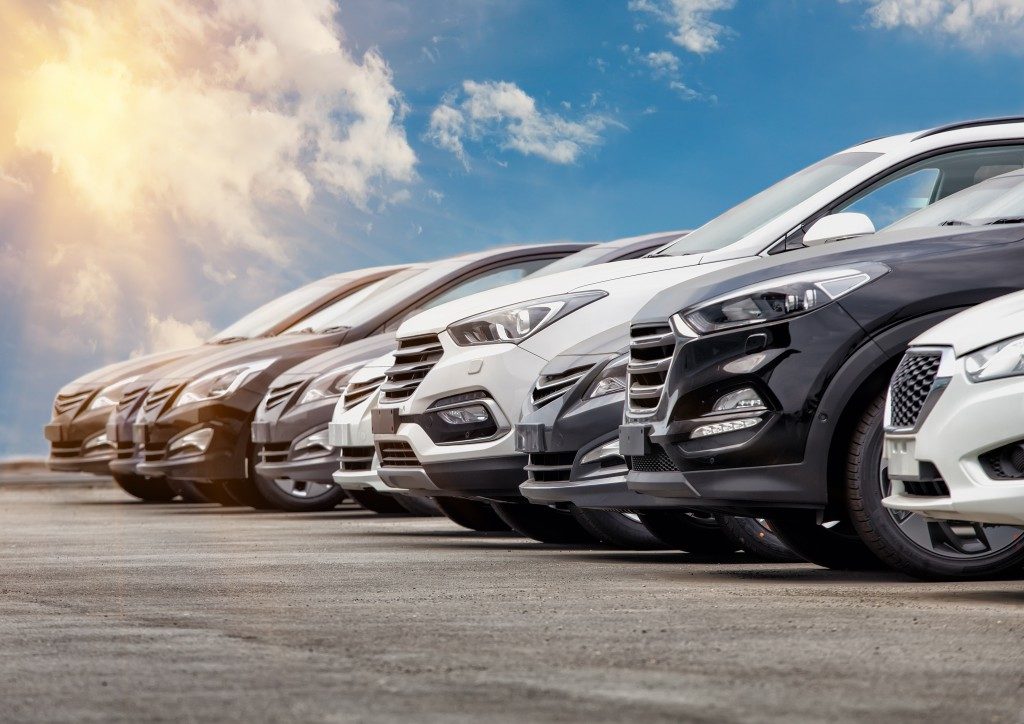 row silver and black cars on the parking lot