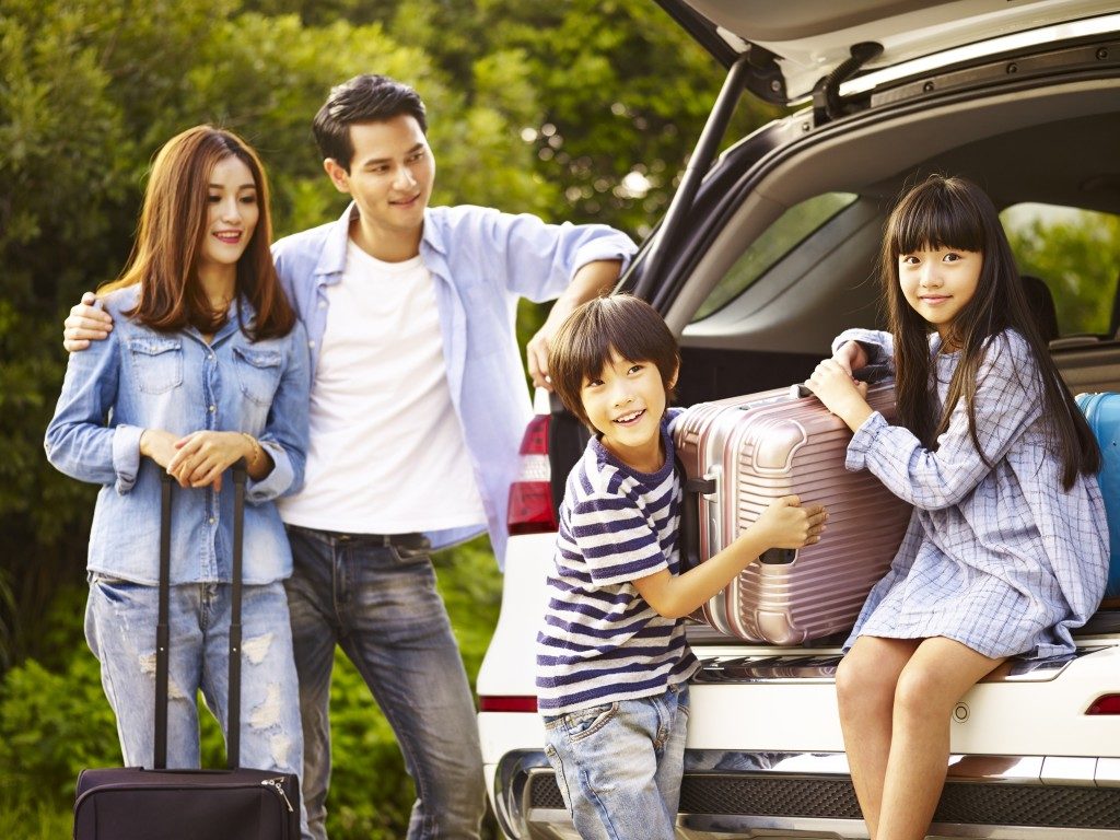 family loading the SUV for a vacation trip