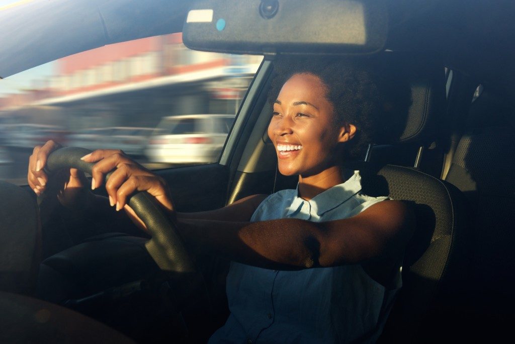 Woman driving the car happily