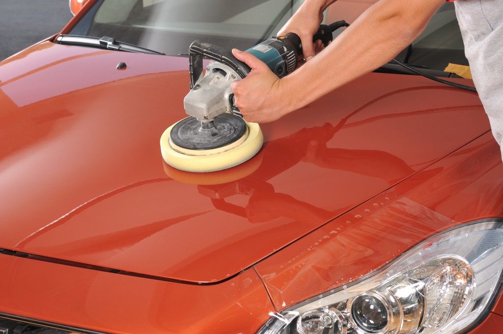 person cleaning a car