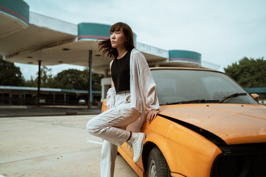 woman leaning on a car