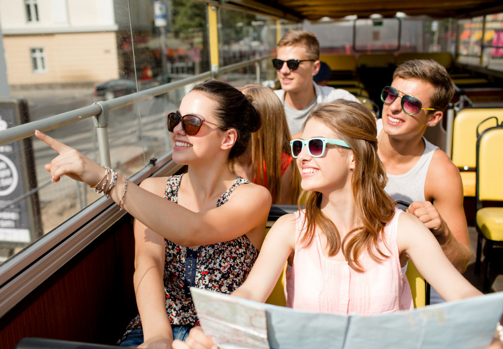 group pf tourists on top of an open bus