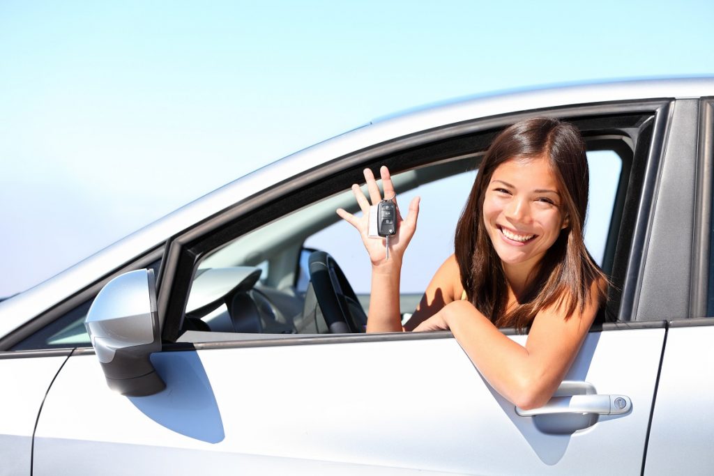 woman inside a car while holding car key