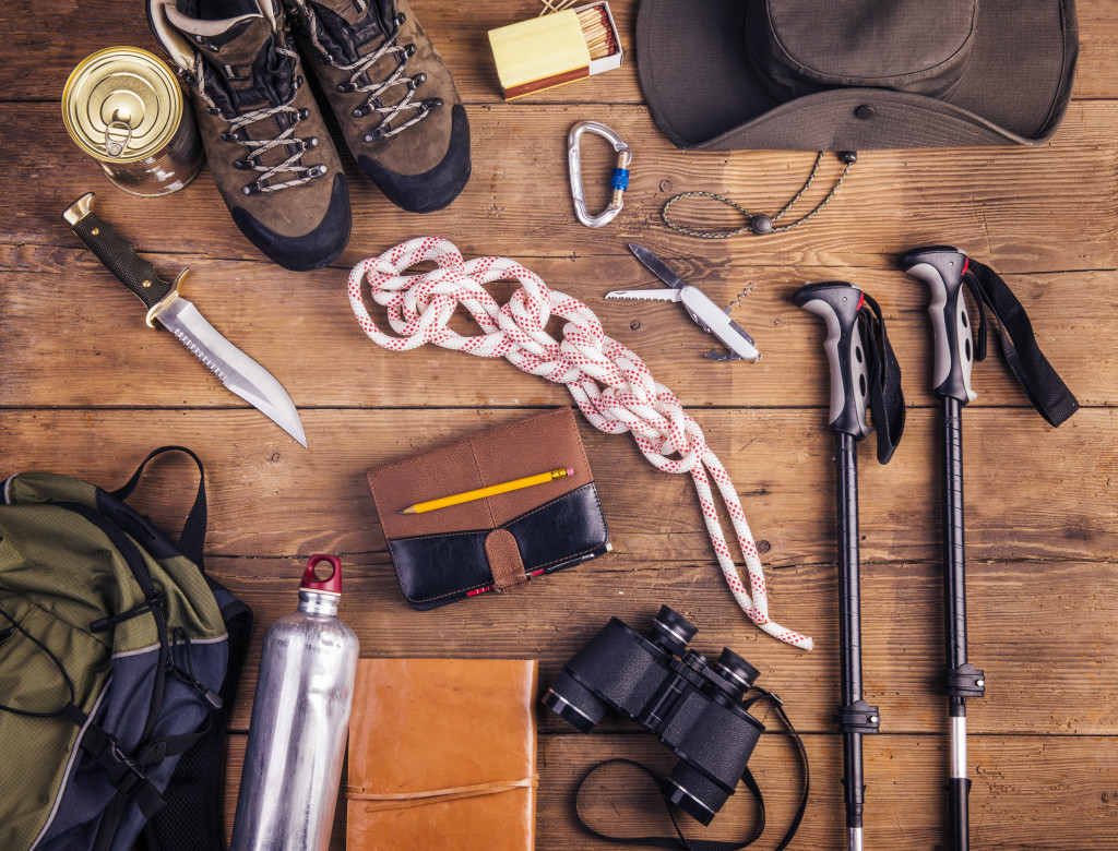 essential travel supplies for hiking in wooden background