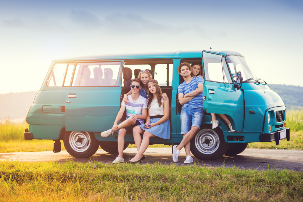 group of friends posing in their car for a road trip