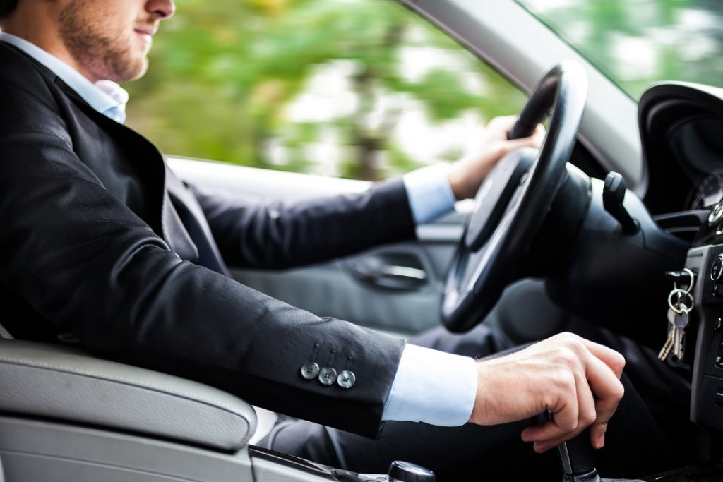 man driving his car